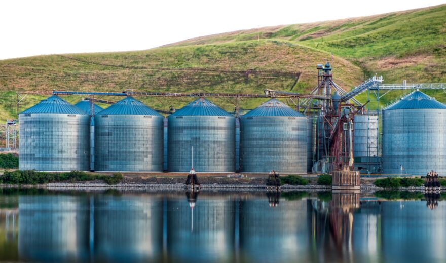 Panoramic shot of industrial buildings on the shore of the lake reflected in the water A panoramic shot of industrial buildings on the shore of the lake reflected in the water